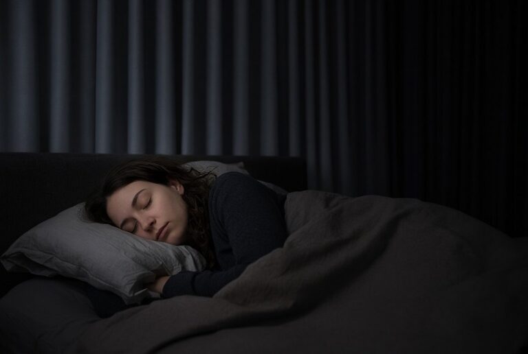 Young woman sleeping during the day in a darkened bedroom after a night shift, sleep and night work